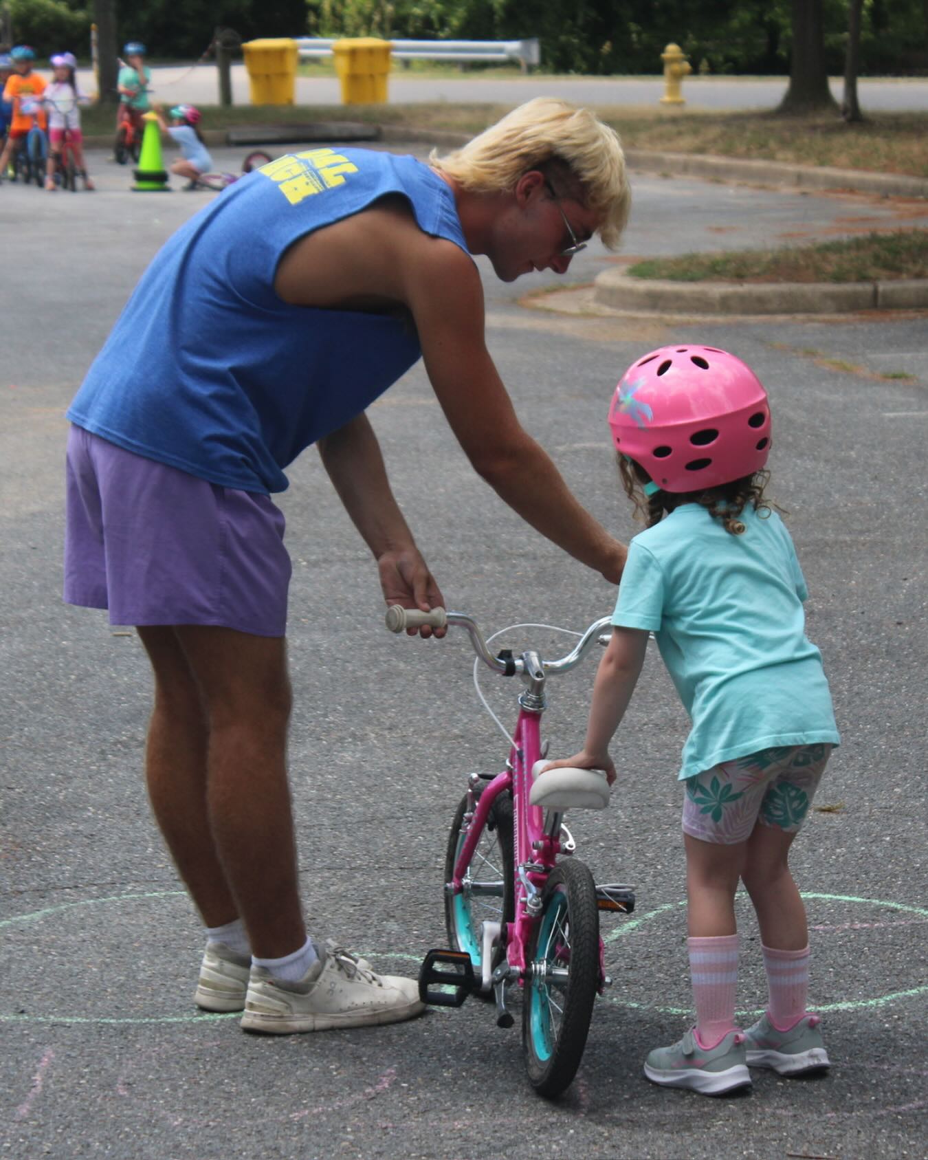 It’s not a matter of “if” you fall off your bike, it’s a matter of when- when we’re pushing our limits, learning new things and operating in the “challenge zone”, accidents are bound to happen. Getting back on the bike is the goal- just like the Japanese proverb says, fall 7 times, rise 8. How adults react to falls is how children will, too. 

Here’s how we handle falls: a calm and reassuring demeanor rather than a panicked rush, a high five or affirmation for trying something hard, and an intentional moment to help the child regulate their emotions and take some deep breaths. 

Sometimes riders want to rush back on, still in tears- often leading to a second crash. That critical calm moment to slow down, breath and do a quick “after accident investigation” is as important as getting back on the bike. 

We help riders look for clues about what happened so that they feel empowered to make changes on their next attempt, r ather than telling them what “they did wrong”. Twisted handlebars? Maybe a clue that they turned to sharply… hit the curb? Where were they looking just before they crashed? 

When new riders take a moment to pause, reflect and strategize for their next attempt, they feel empowered rather than panicked, hopeful rather than hesitant.